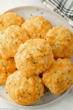 a white plate topped with cheesy biscuits