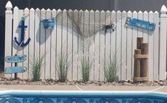 a white picket fence next to a swimming pool