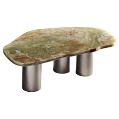 a stone bench sitting on top of metal legs