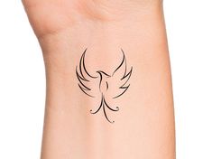 a woman's arm with a small tattoo on the back of her left arm