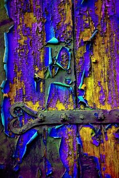 an old wooden door with peeling paint on it