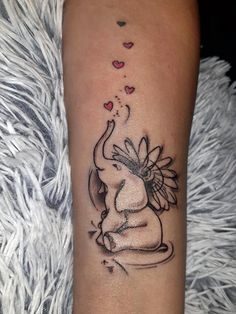 an elephant with hearts on its back and tail is sitting in front of the arm