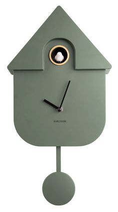 a green clock with a hole in the middle and an eye on it's face