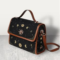 "Cottagecore Celestial Canvas Satchel bag, Kawaii Witch Moon Phases Crossed body vegan leather strap hand bag, goth bag, hippies boho gift >>PRODUCT INFO<< * 18.94 Oz. Made from high-grade waterproof canvas, durable, water-resistant. * Can be used as a nice laptop storage bag, business briefcase, college school bag, leisure travel tote bag, crossbody messenger bag, card wallet case, etc. * Two interior pockets for small items one zipper pocket. * Removable and adjustable shoulder strap. * The sh Things To Buy For High School, Gifts For Goths, Black Bohemian Shoulder Bag With Detachable Strap, Gifts For Hippies, Witch Moon Phases, Cottagecore Items, Goth Bags, Cute Messenger Bag, Bag Design Ideas