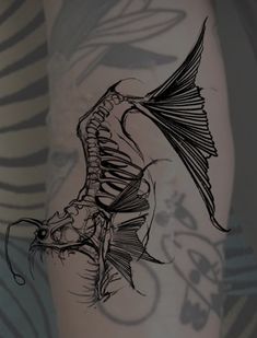 a black and white drawing of a fish on someone's leg with the skeleton visible