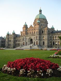 a large building with flowers in front of it