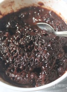 a bowl filled with chocolate pudding and a spoon