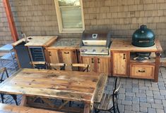 an outdoor bbq and picnic table set up on a patio