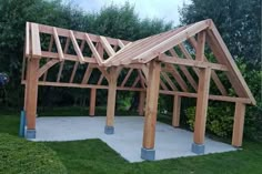 a wooden structure sitting on top of a lush green field