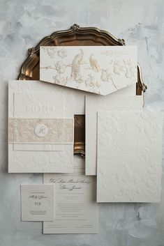 the wedding stationery is laid out on top of each other, with an ornate design