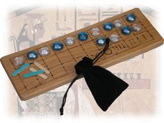 a wooden ruler with blue glass knobs on it and a black bag next to it