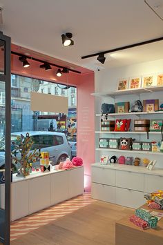 the inside of a store with lots of items on display in front of large windows