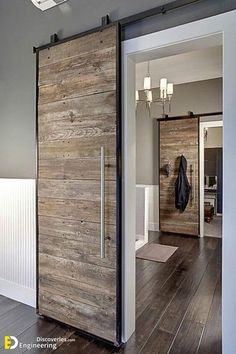 an open sliding door in the middle of a room with wood floors and white walls