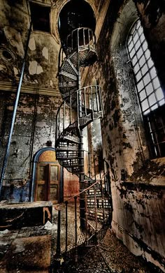 a spiral staircase in an abandoned building