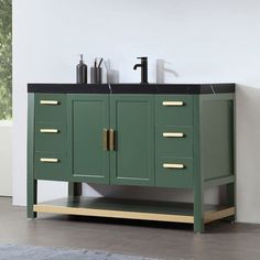 a bathroom vanity with two sinks and green cabinet