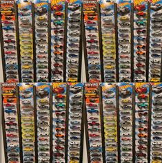 a bunch of hot wheels toys are stacked up