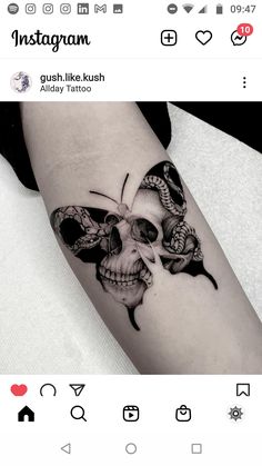 a black and white photo of a skull with two butterflies on it's arm