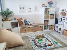 a child's playroom with toys and bookshelves on the floor, including a toy train