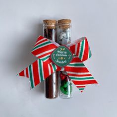 two christmas candies in glass bottles with ribbons