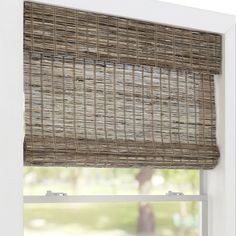 a window with a bamboo blind in front of it