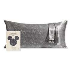 the mickey mouse pillow is next to its packaging