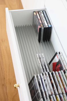 an open drawer with several dvds in it