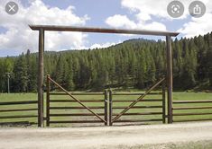 an open gate in the middle of a field