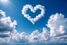 a heart shaped cloud floating in the sky above water with sun shining on it's side