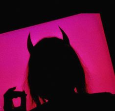 the silhouette of a woman with horns on her head