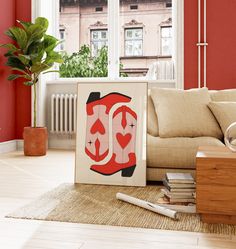 a living room filled with furniture and a painting on top of a wooden table next to a window