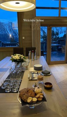 a dining table is set with desserts and wine glasses