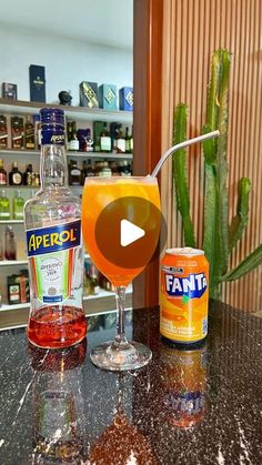 an orange drink sitting on top of a counter