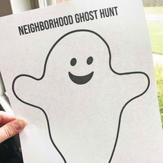 a person holding up a poster with a ghost drawn on it's face and the words neighborhood ghost hunt