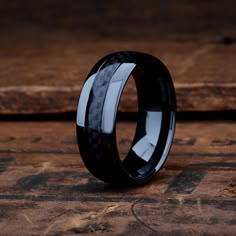 a black and white wedding ring with carbon fiber inlays on the inside of it