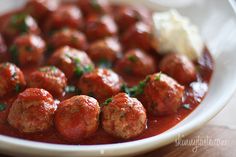 some meatballs are covered in sauce and garnished with parsley