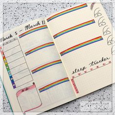 an open planner book with rainbows on it