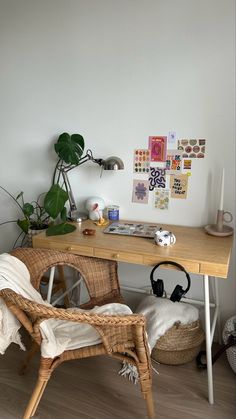 a wicker chair sitting in front of a wooden desk