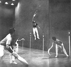 an old black and white photo of some people doing tricks in the air with tennis rackets