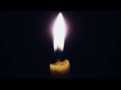 a candle is lit up in the dark