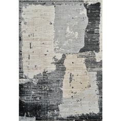 an area rug with different colors and shapes on the floor, including black, white, grey