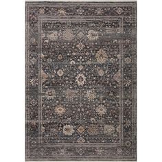 an area rug with various colors and patterns on the floor, including dark blue tones