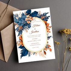 a wedding card with blue and orange flowers