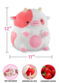 the stuffed animal is pink and white with brown spots on it's face, sitting next to strawberries