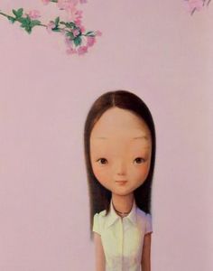 a doll is standing in front of a pink wall