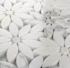 white marble flowers are arranged on top of each other in the shape of circles and petals