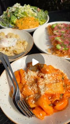 several plates with different types of food on them and one has a fork in it