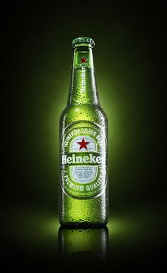 a bottle of heineken beer on a dark background