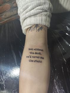 a person with a tattoo on their arm that says, but without the dark we'd never see the stars