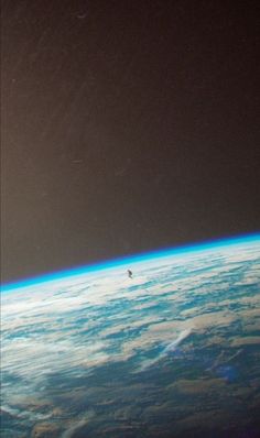 an airplane flying over the earth at night