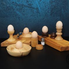 an assortment of different types of eggs in wooden bowls